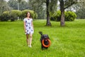 Black briard shaggy dog plays with toy outdoor.