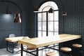 Black brick cafe corner, wooden tables close up Royalty Free Stock Photo