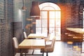 Black brick cafe, wooden tables side toned Royalty Free Stock Photo