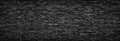 Black brick wall background.  stonework texture gloomy, panoramic view Royalty Free Stock Photo