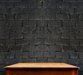 Black brick wall and wooden table,perspective background