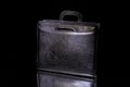 Black briefcase for papers and documents on a black background. Business style. For businessmen. Royalty Free Stock Photo