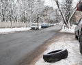 Black broken car wheel tyre beside road Royalty Free Stock Photo