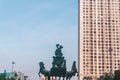 Black bronze statue of a horse-drawn carriage in the center of high-rise buildings of the Royal City luxury apartment complex