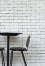 Black brown chair and table with white brick indoor background