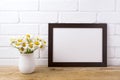 Black brown landscape frame mockup with chamomile bouquet in ru