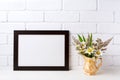 Black brown landscape frame mockup with chamomile and grass in Royalty Free Stock Photo