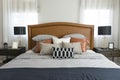 Pillows setting on bed with brown leather headboard