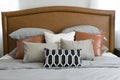 Pillows setting on bed with brown leather headboard