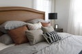 Pillows setting on bed with brown leather headboard Royalty Free Stock Photo