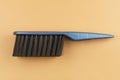 Black brush with blue handle on beige Royalty Free Stock Photo