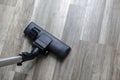 Dark head of a modern vacuum cleaner on wood floor Royalty Free Stock Photo