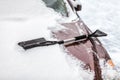 Black brush lying on car covered in snow Royalty Free Stock Photo