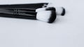 Black brushes with white and black pile for makeup of different sizes lie on a white background on top. top view, flat Royalty Free Stock Photo