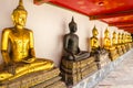 Black Buddha between Golden Buddhas