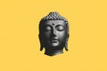 Black Buddha Head Statue on Yellow Background Royalty Free Stock Photo