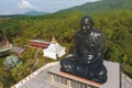 Black Buddhist Sitting Meditation Monk Statue. Wat Kaeo Manee Si Mahathat Temple. Aerial Shot from Above. Phang Nga