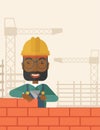 Black builder man is building a brick wall