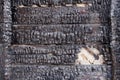 Black burnt wall of house of wooden planks with embossed texture. damage to the building from fire without the possibility of Royalty Free Stock Photo