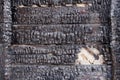 Black burnt wall of house of wooden planks with embossed texture. damage to the building from fire without the possibility of