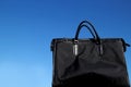 Black business bag in the blue sky