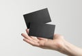 2 black business card floating above a hand Mockup. Empty calling card. Generative ai Royalty Free Stock Photo