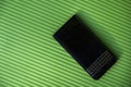 Black business smartphone on green background