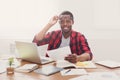 Black businessman in casual office, workplace with laptop and paperwork Royalty Free Stock Photo