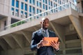 black businessman looking at his tablet computer in urban background01