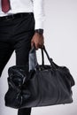 Black businessman man holding a large black business travel bag in his hand Royalty Free Stock Photo