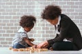 Black businessman mother playing with her children together in the house learning concept Royalty Free Stock Photo