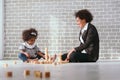 Black businessman mother playing with her children together in the house learning concept Royalty Free Stock Photo