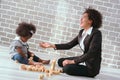 Black businessman mother playing with her children together in the house learning concept Royalty Free Stock Photo