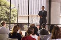 Black businessman presenting seminar smiling to audience