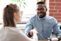 Black businessman shaking hands with caucasian young businesswoman Royalty Free Stock Photo