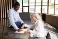 Black Businessman Signing Employment Contract With Employee Woman In Office Royalty Free Stock Photo