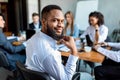 Black Businessman Smiling To Camera Sitting On Meeting In Office Royalty Free Stock Photo