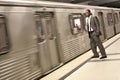 Black Businessman Watching the Metro Train Pass