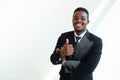 Black businessman wearing a suit shows his thumb up on white background Royalty Free Stock Photo