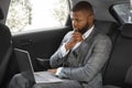 Black businessman working on laptop while going to business meeting Royalty Free Stock Photo