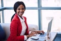 Black businesswoman smiling at the camera while seated on sofa Royalty Free Stock Photo