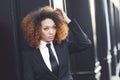 Black businesswoman wearing suit and tie in urban background Royalty Free Stock Photo