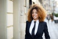 Black businesswoman wearing suit and tie in urban background Royalty Free Stock Photo