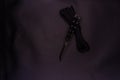 Black Butterfly Knife. Black rope on a black background. Royalty Free Stock Photo