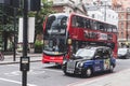 Black cab and Red Double Decker bus are waiting on the traffic light in London Royalty Free Stock Photo