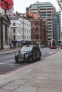 Black cab waiting on traffic light Bishopsgate, City of London