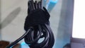 Black cable of fastened laptop charger