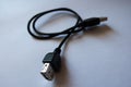 Black cable with male and female USB connectors Royalty Free Stock Photo