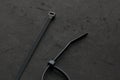 Black cable ties on a black surface Royalty Free Stock Photo