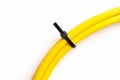 Black cable ties on yellow cable isolated on white background. object picture for graphic designer Royalty Free Stock Photo